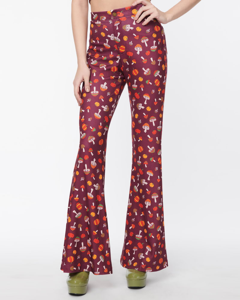 Front of a model wearing a size 4X Smak Parlour Purple Pumpkin & Mushrooms Find Your Flare Pants in Purple by Smak Parlour. | dia_product_style_image_id:310147